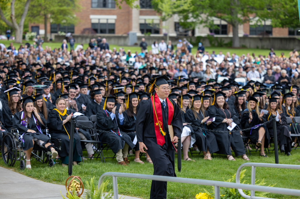 Student approaches the podium to deliver his speech at the Keuka College commencement.