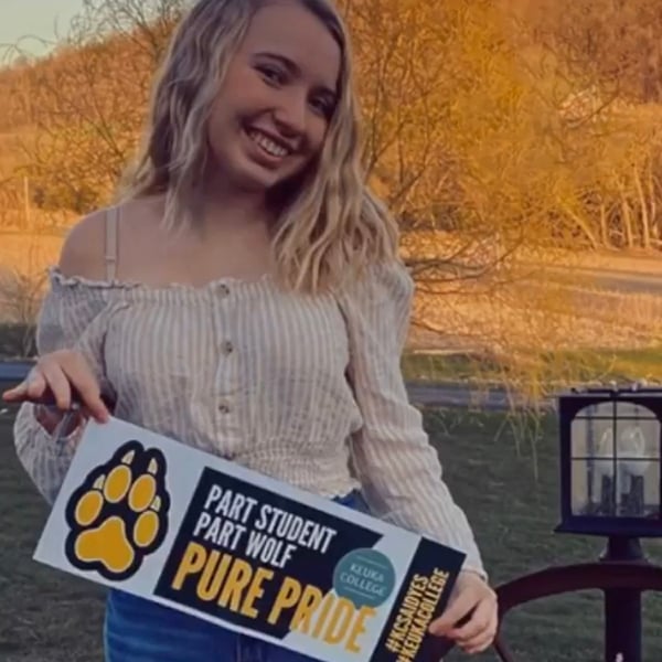ASD student holding Pure Wolf Banner