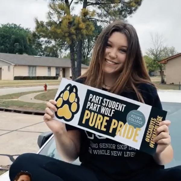 ASD student holding Pure Wolf Banner