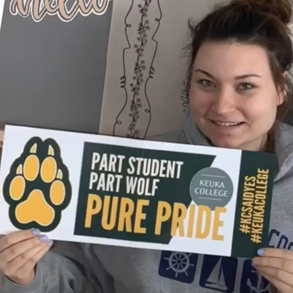 ASD student holding Pure Wolf Banner