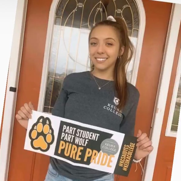 ASD student holding Pure Wolf Banner
