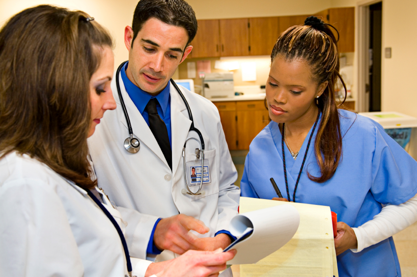 nurses and doctors reviewing a patient file