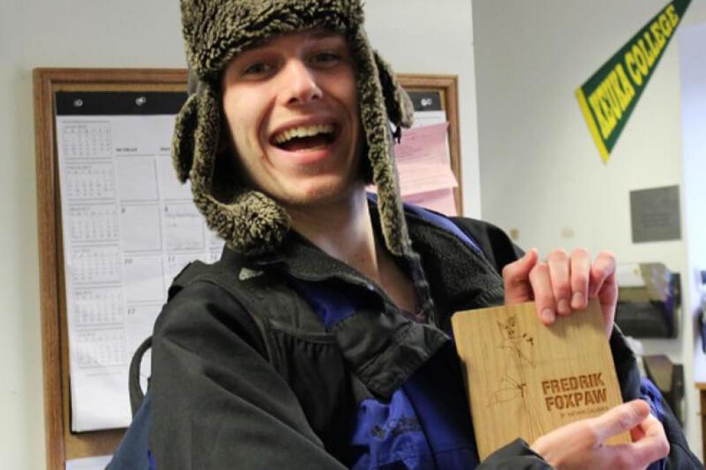 student holding an award