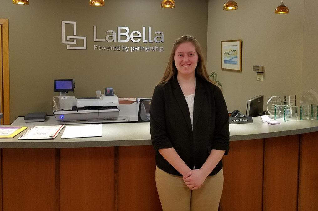 Sydnie Brown standing in front of the LaBella Associates reception area