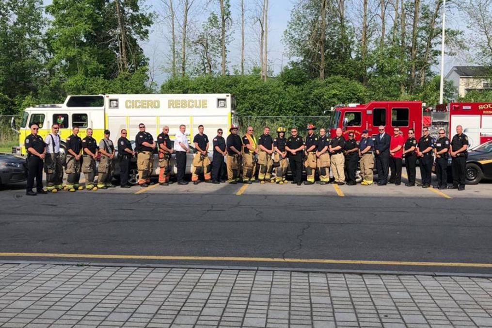 Justin Latz '19 poses with members of the Town of Cicero's fire and police departments. Through Field Period®, Justin was able to learn the ins and outs of both departments.