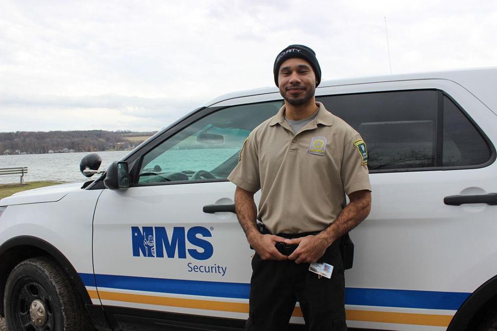 NMS Security Officer Paden Frenney stands at Point Neamo, where he pulled two men from the icy waters of Keuka Lake over the winter.