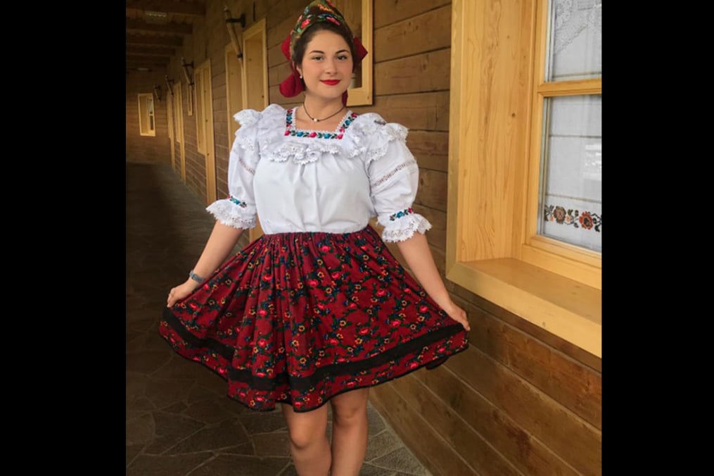Ashley DeFreitas poses for a photo while on her Field Period dressed in traditional Romanian dressy clothing