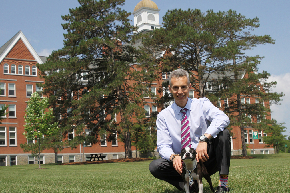 Dr. Bradley Fuster poses on campus with his rescued Boston Terrier, Rocket. 
