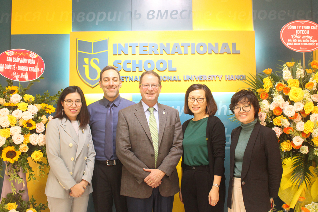 Keuka College's Dean of International Programs, Asia Gary Giss, second from left, and Vice President for Enrollment Management & Student Development Mark Petrie, center, poses with partners during a visit to Vietnam National University in Hanoi, Vietnam, in December. (Photo provided)