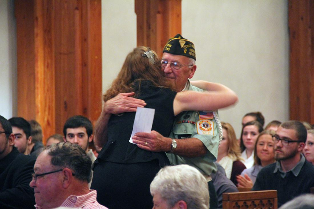 A Keuka College student hugs the honor flight recipient.
