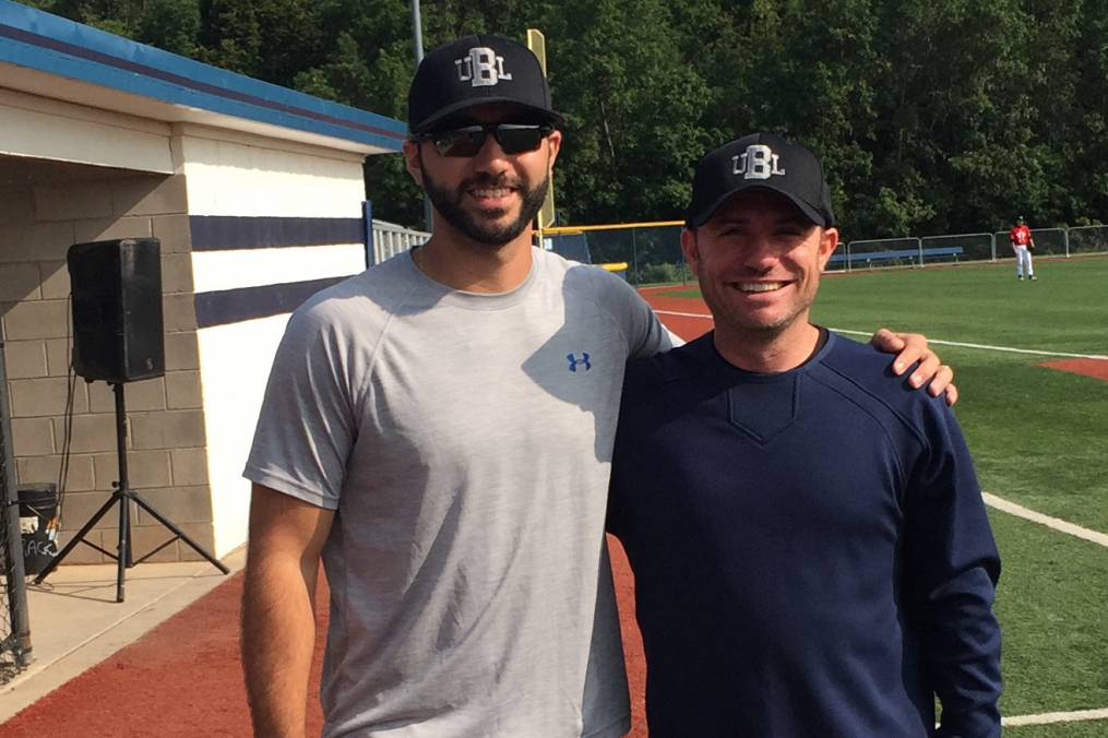 Keith Prestano ’13, left, poses with fellow local baseball league owner Joe Bianchi at the Basket Road field in Webster.
