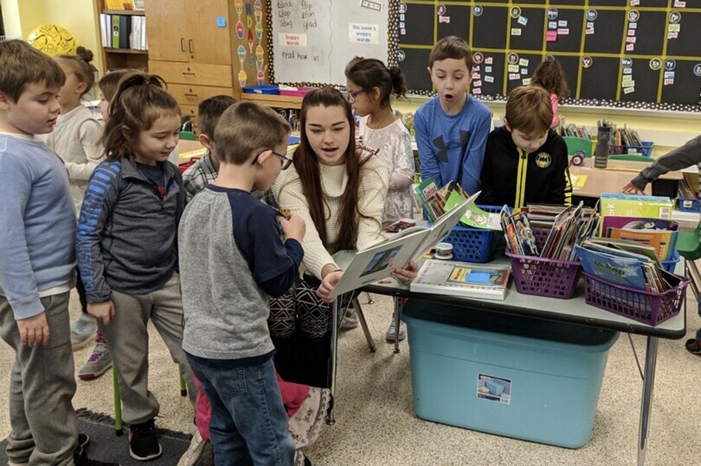 Student works with children in school during field period for keuka college