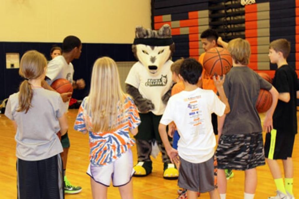 Kacey helping with young kids on basketball court