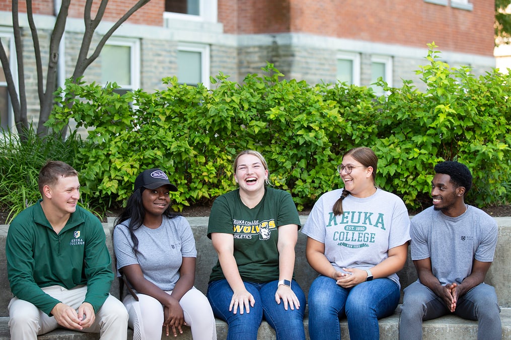 Students sitting in front of Ball Hall 