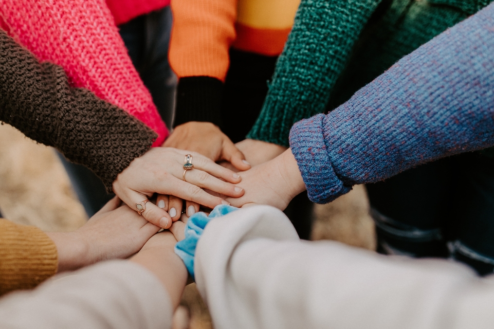 Hands piled together for a group huddle