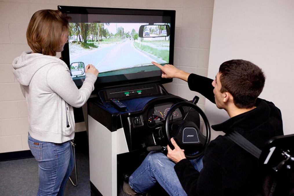 students sitting around a driving simulation