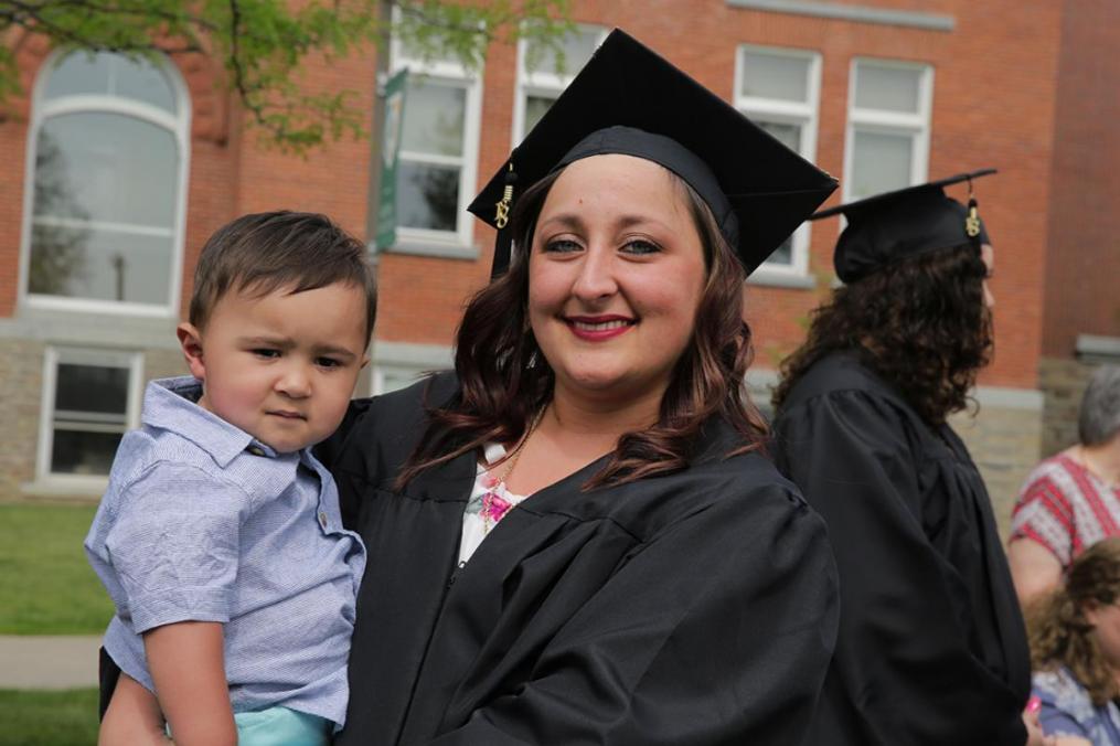 Criminal Justice Systems major Kiraly Zepp attended graduation ceremonies with 10-month-old son Carlos Colon.