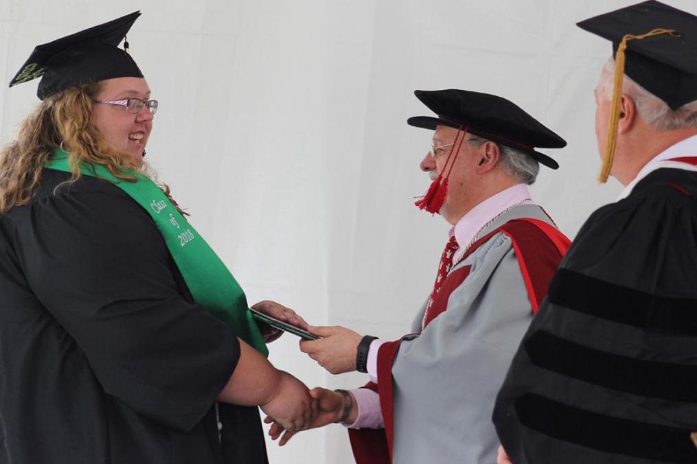 American Sign Language-English Interpreting major Sarah Hauser receives her diploma from College President Dr. Jorge L. Díaz-Herrera.