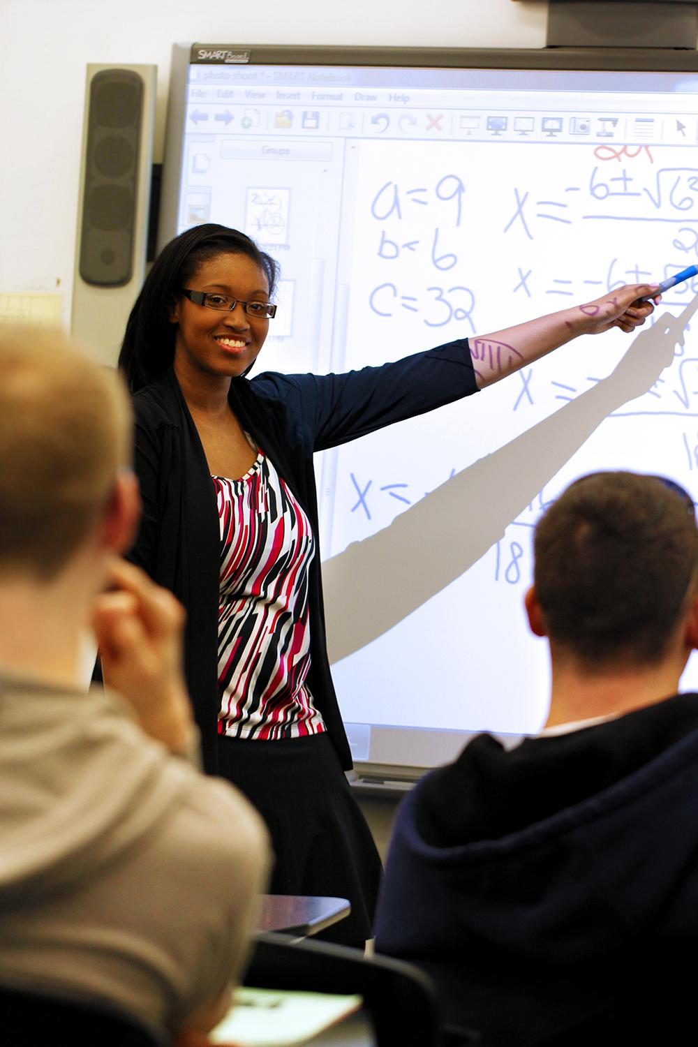 A math teacher helps students read.