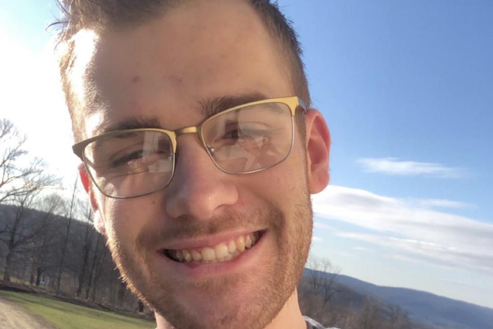 Michael Chapman, a Nursing student, stands outside the campus.