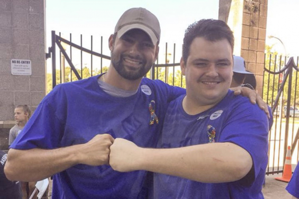 Joe Maier '16 M'17 (left) fist-bumps his friend, Dalton Letta, during a walk to raise awareness for autism. 