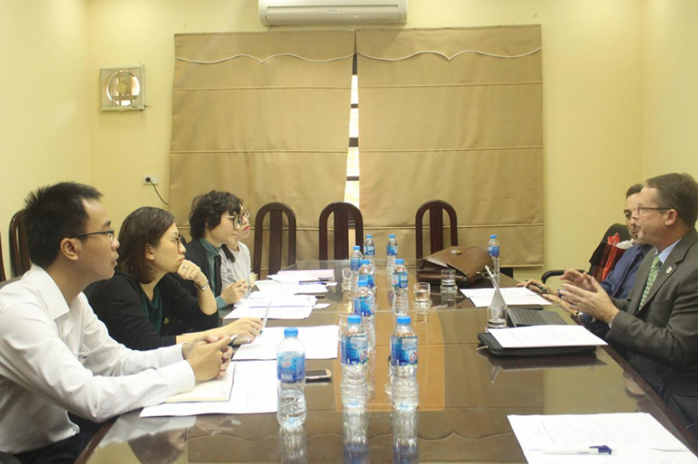 people sitting around a conference table having a discussion