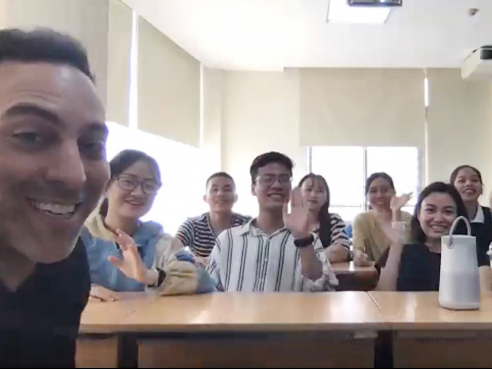 Associate Professor Gary Giss and his Leadership class in Duy Tan, Vietnam, greet their stateside counterparts during a video class with Keuka College students.