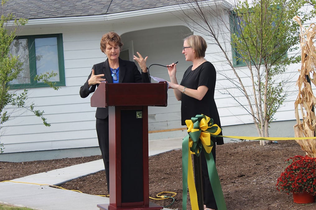 Associate Professor of ASL/ASL English Interpreting Dr. Marla Broetz, left, addresses the crowd at the formal ribbon-cutting for the new American Sign Language/ASL English Interpreting facility on Saturday, Sept. 28. 