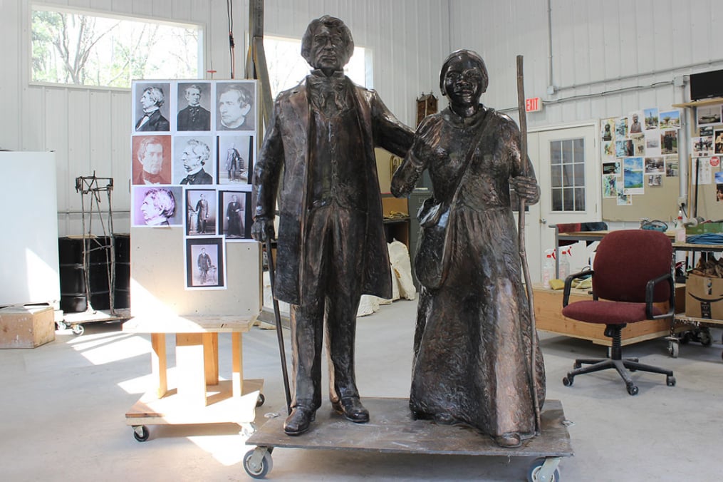 In creating his works, Professor Emeritus Dexter Benedict uses a photo board to help bring expression to those he sculpts, like the one he used for William Seward (l).
