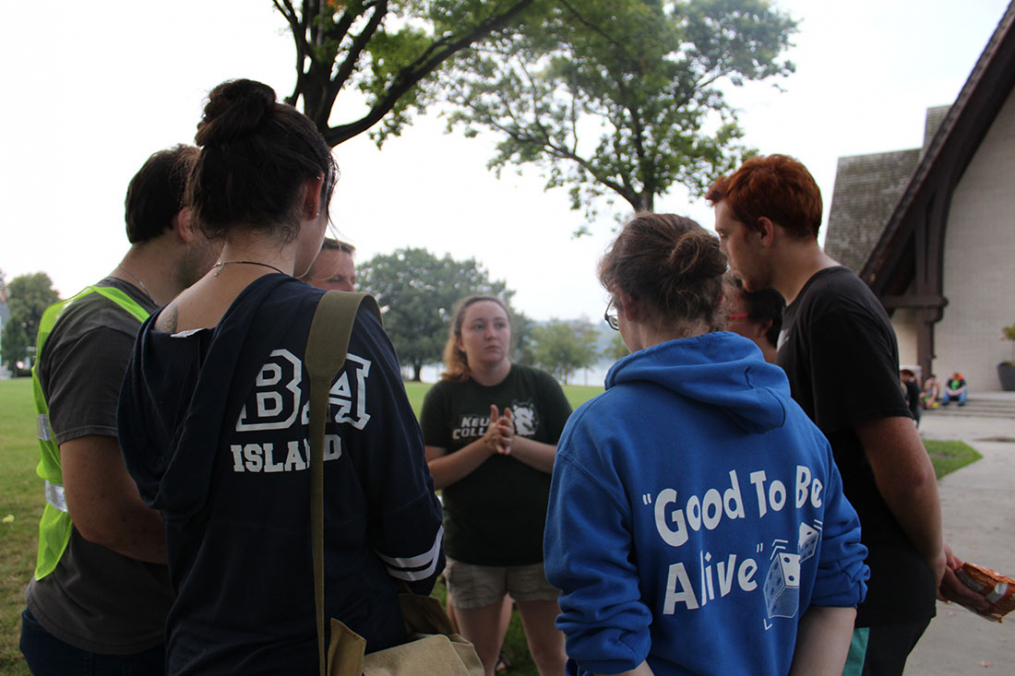 A group of students pause during the 2017 One Walk to listen to statistics about suicide.
