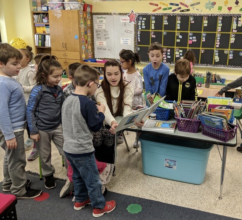 Student works with children in school during field period for keuka college