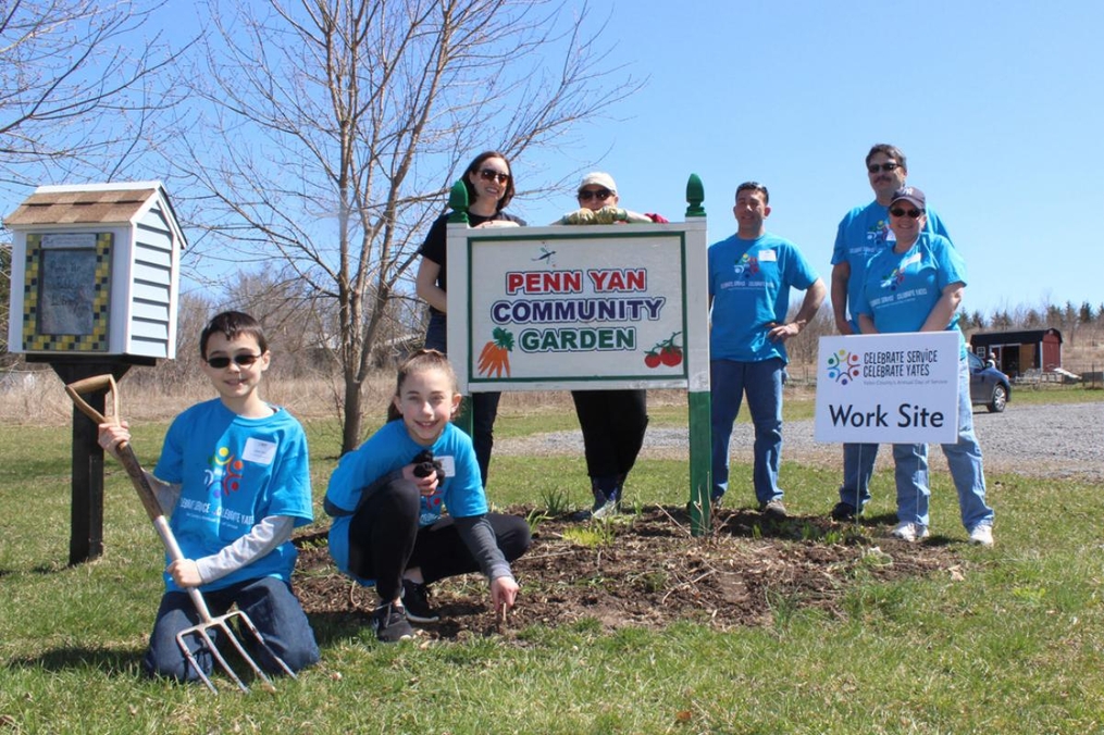 students posing by Penn Yan Community Garden
