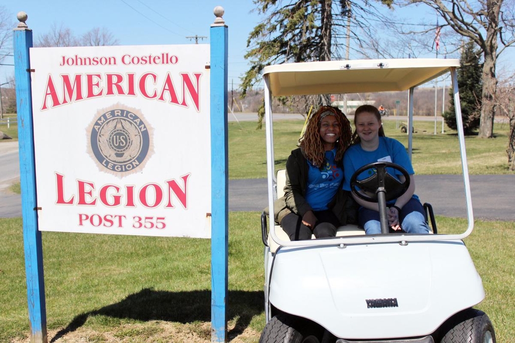 students posing in a golf cart at the American Legion