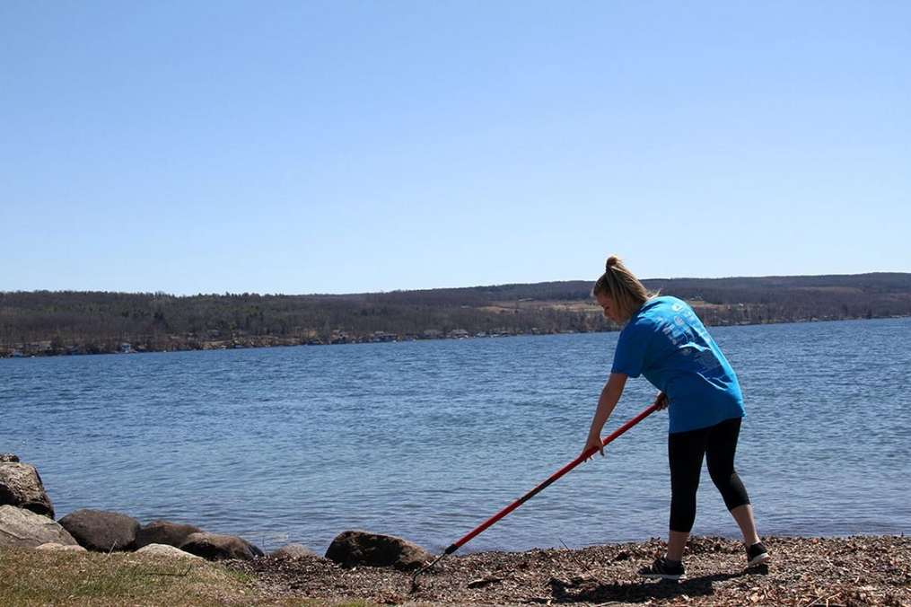 student raking the shore