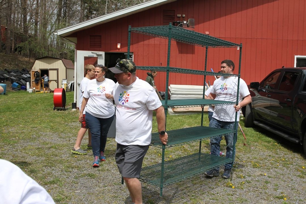 CSCY Volunteers carrying shelving unit 