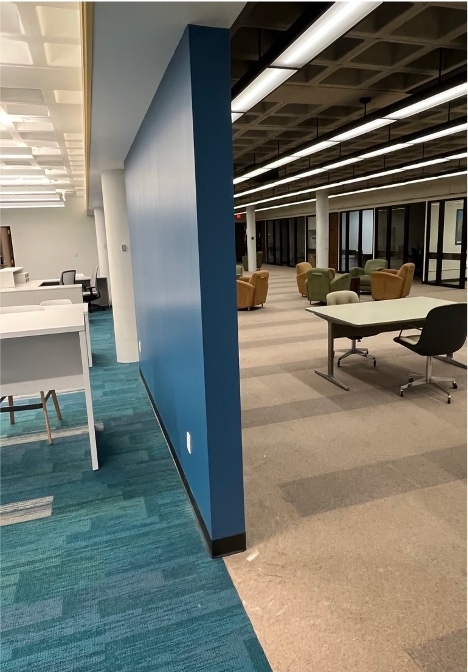 A split view of where the renovated areas of Academic Commons was completed and on the other side of the wall the unfinished area where phase 2 will begin.