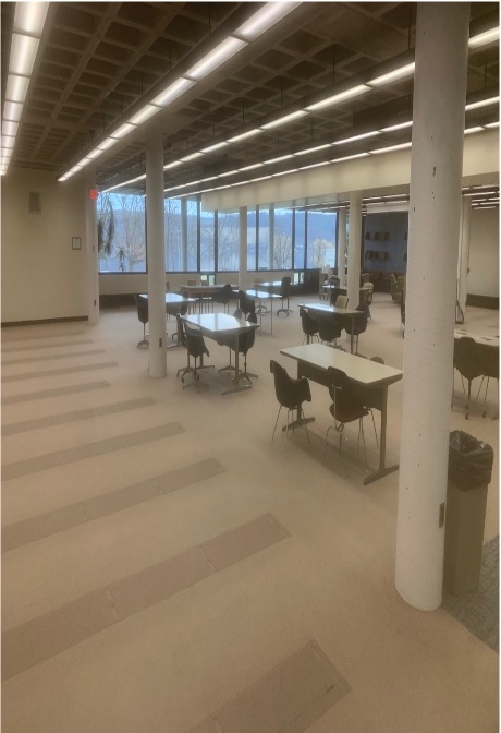 Tables and chairs in the unrenovated area of the downstairs of Lightner Library