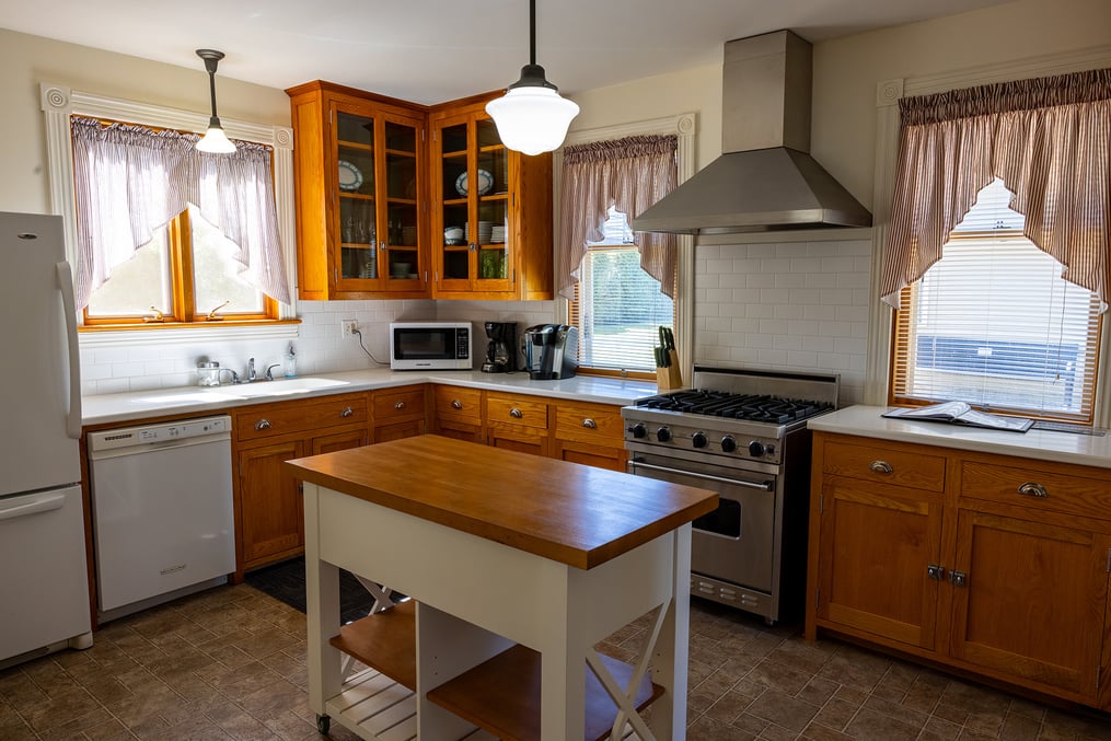 Photo of the gas stove and island counter in the alumni house kitchen