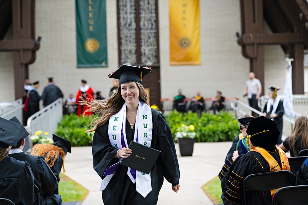 Nursing student Chloe Sears walking with diploma