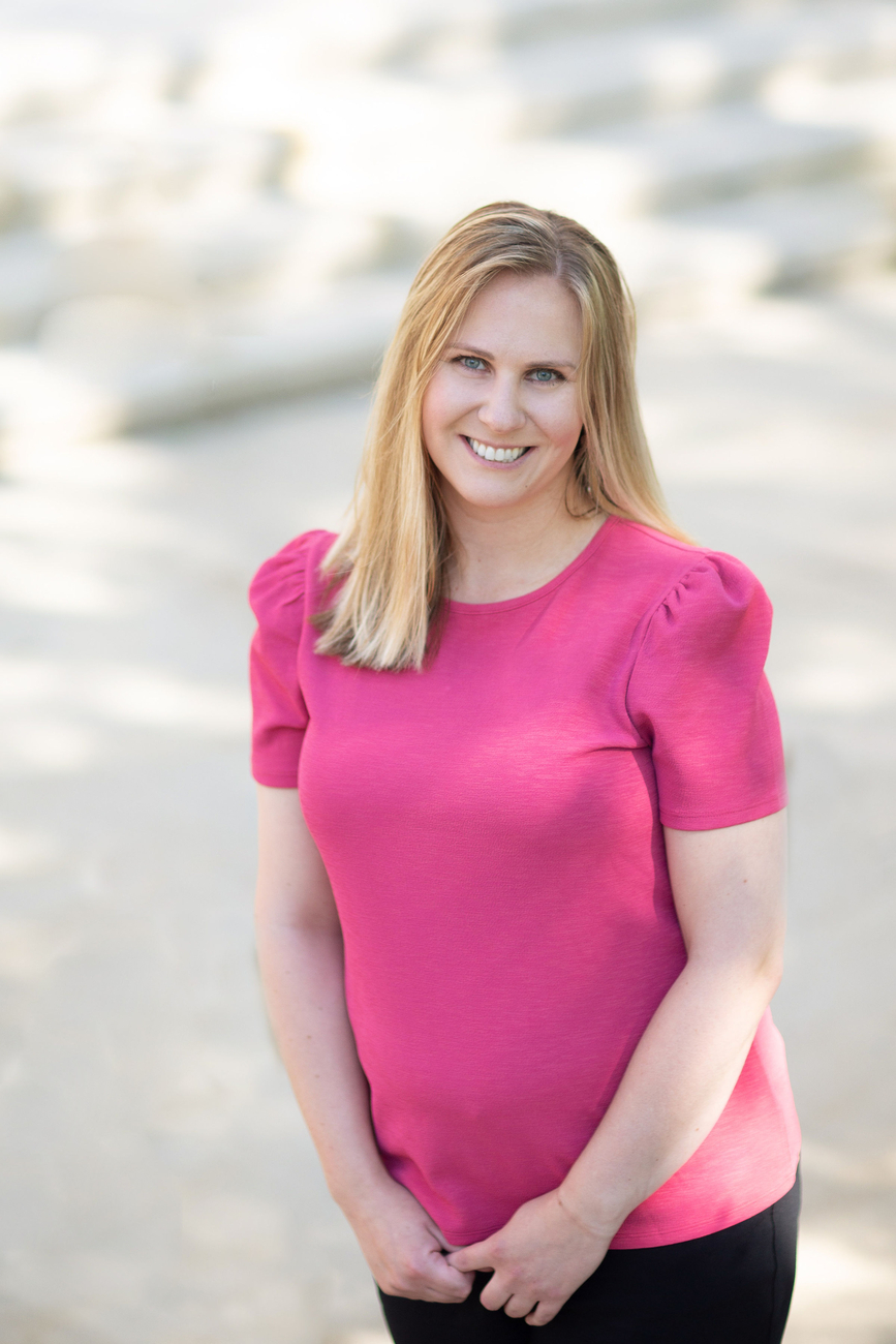 A photo of Jacqui in a pink shirt.